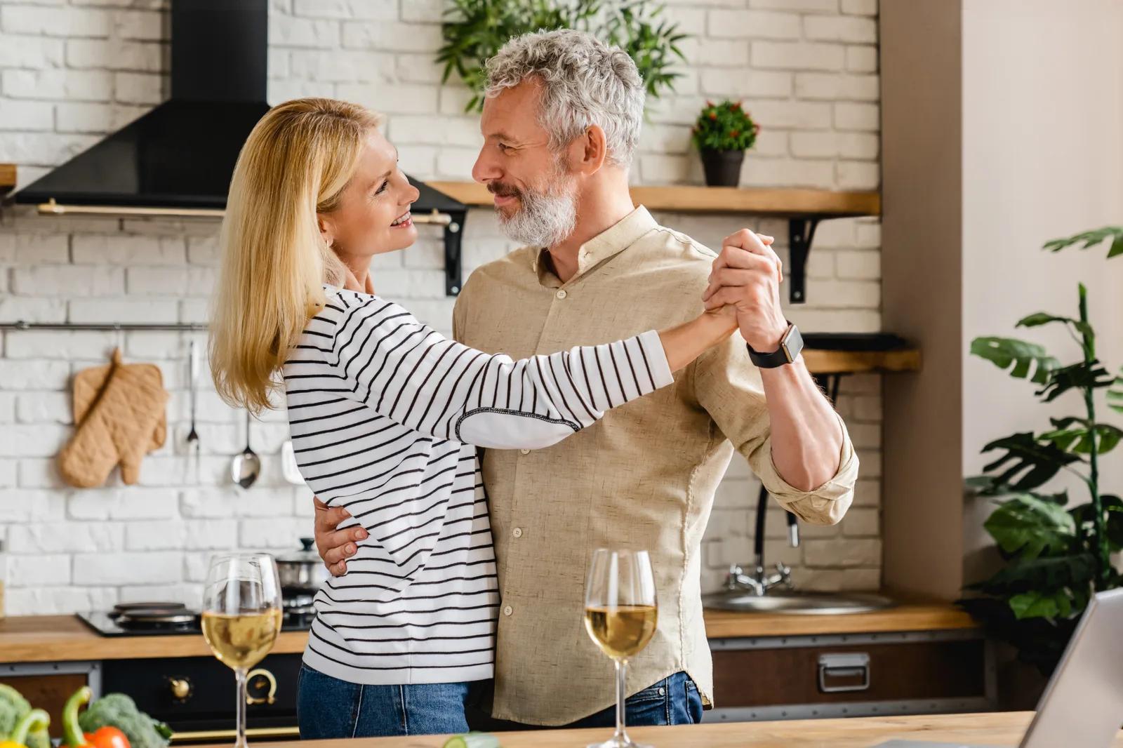 A couple laughing together at home